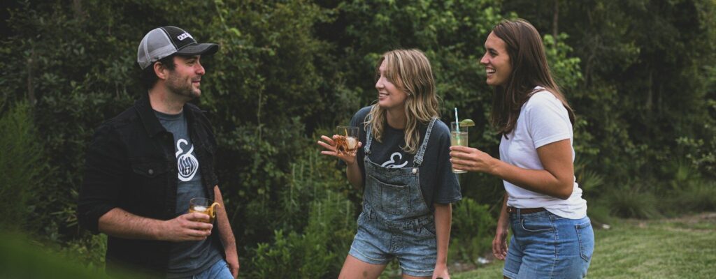 woman in black crew neck t-shirt and blue denim shorts standing beside woman in white